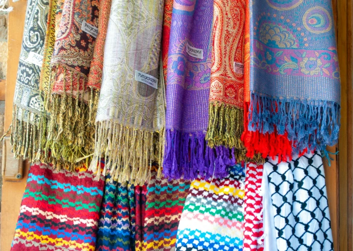 Colorful scarves and textiles displayed for sale.